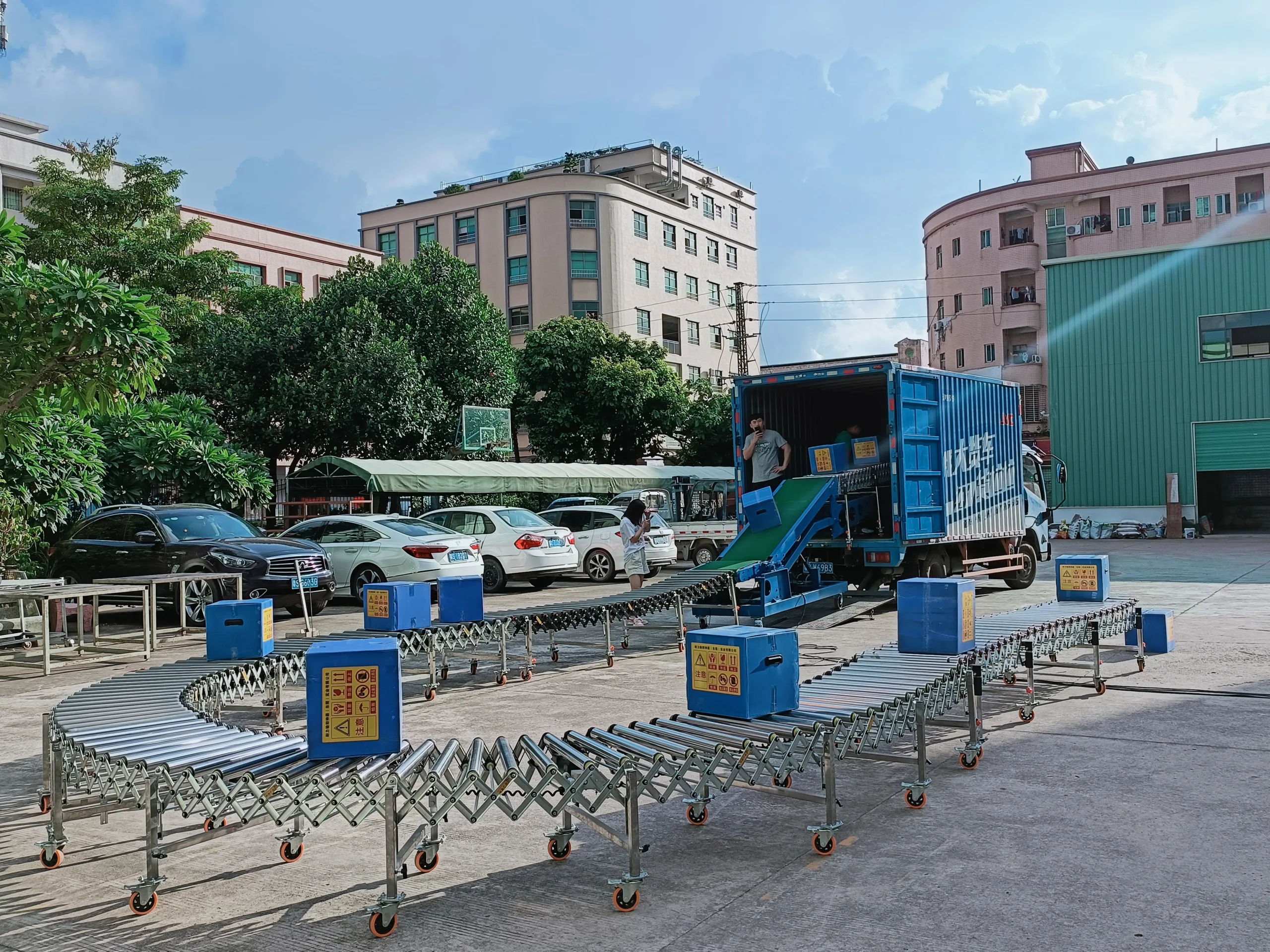flexible powered roller conveyor loading goods onto a medium truck