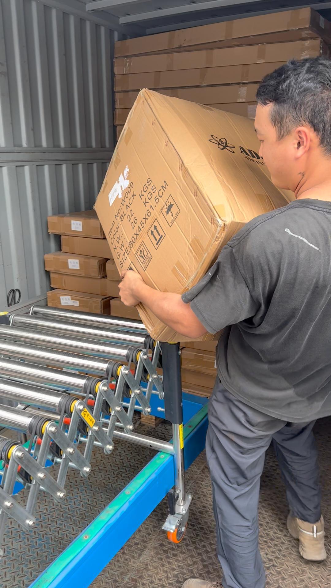 Unloading heavy goods from truck with hydraulic conveyor and roller conveyor